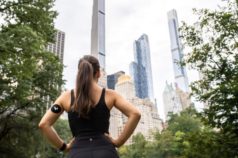 Woman looking at buildings in park levels patch