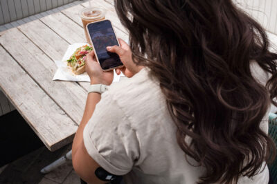 Woman eating and logging food app