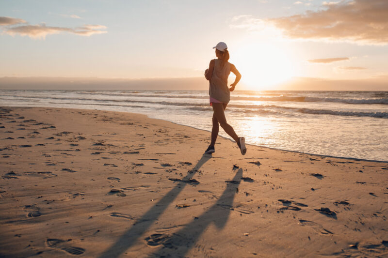 Woman running on beach menopause